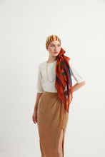 Load image into Gallery viewer, Discover the harmony of tradition and contemporary elegance with this timeless wool shawl. This large hand-stitched shawl radiates warmth through its tones of red, orange, green, blue sunset colours, evoking a vibrant energy and life-giving power.