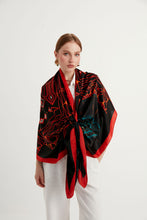 Charger l&#39;image dans la galerie, Discover the harmony of tradition and contemporary elegance with this timeless crepe silk shawl. This large shawl with mythological motifs, radiates warmth through red, black and white main colours, evoking a vibrant energy and life-giving power .
