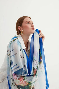Istanbul Silhouettes chiffon shawl is a tribute to the captivating charm of Istanbul, unifying the natural and historical elements of the city, capturing the soothing tones of the Bosphorus and the blue sky with fractal patterns in a modern palette.