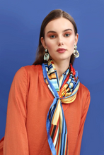 Charger l&#39;image dans la galerie, FLAME Collection 35&quot;x35&quot; Silk Scarf pays tribute to the intertwined nature of fire - growing and evolving, by this elongated design of intersecting colours of flame and heat. Produced in limited numbers, hand-rolled on edges and hand stitched.
