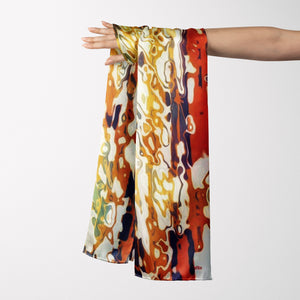 FLAME Collection 27"x78" Large Silk Shawl pays tribute to the intertwined nature of fire - growing and evolving, by this elongated design of intersecting colours of flame and heat. Produced in limited numbers, hand-rolled on edges and hand stitched.